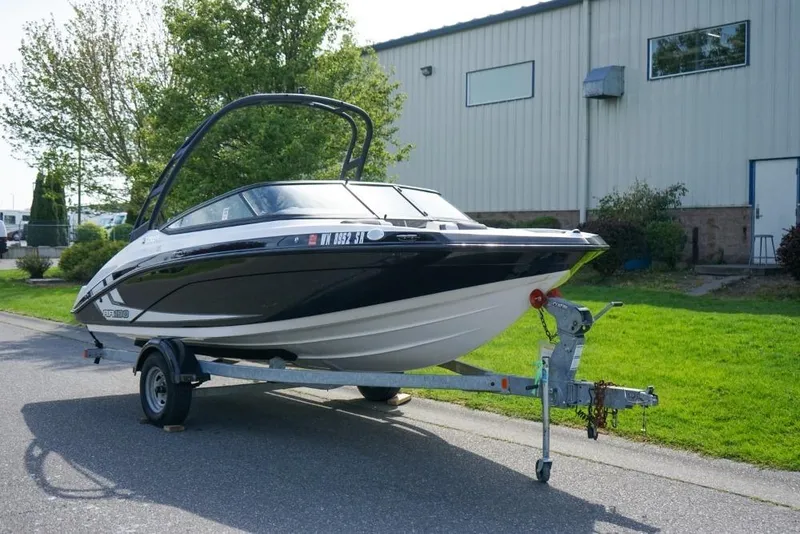 The Image of 2019 Yamaha Boats AR190 on trailer, parked outdoors near a building. - 1