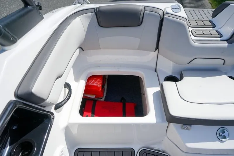 Slide: The Image of 2019 Yamaha Boats AR190 interior storage compartment with safety equipment. - 10