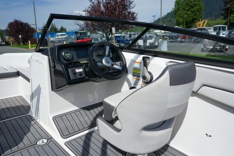 Slide: The Image of 2019 Yamaha Boats AR190 cockpit with steering wheel and controls, featuring sleek design and modern dashboard. - 11