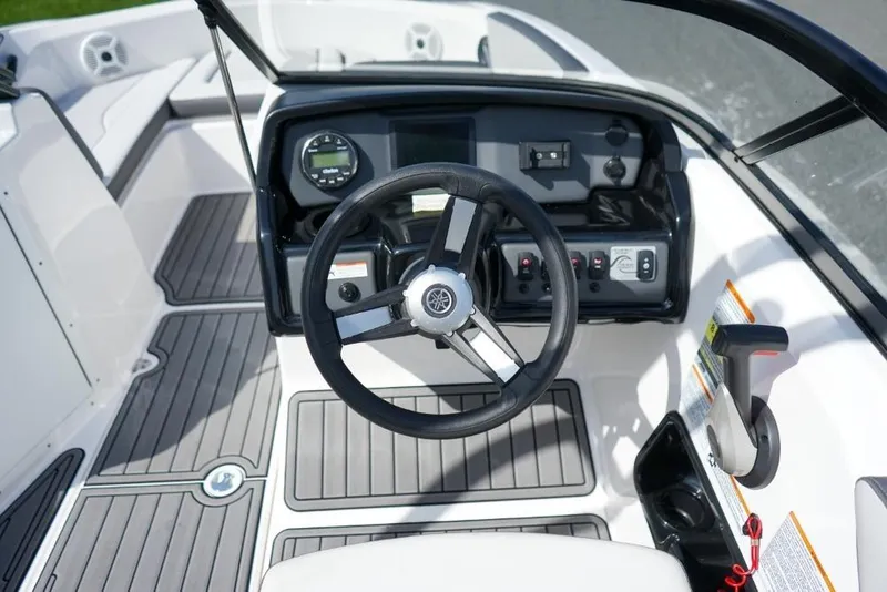 Slide: The Image of 2019 Yamaha Boats AR190 cockpit with steering wheel and control panel. - 12