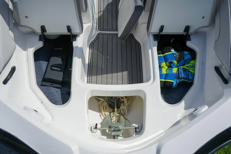 Slide: The Image of 2019 Yamaha Boats AR190 interior storage compartments with life jackets and anchor. - 17