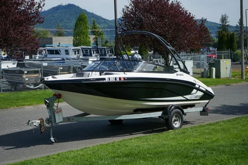 Slide: The Image of 2019 Yamaha Boats AR190 on trailer, parked outdoors with scenic mountain backdrop. - 18