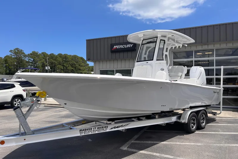 Slide: The Image of 2026 Tidewater 2500 Carolina Bay boat on trailer outside dealership. - 1