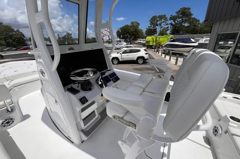 Slide: The Image of 2026 Tidewater 2500 Carolina Bay boat interior with steering console and seating. - 13