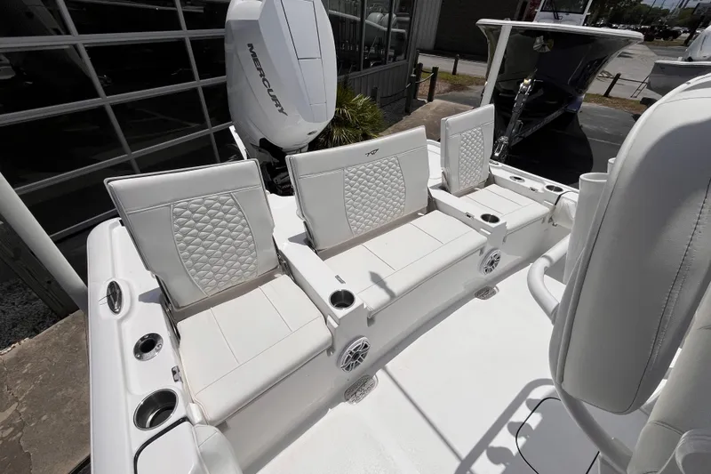 Slide: The Image of 2026 Tidewater 2500 Carolina Bay boat with white seating and Mercury engine. - 5