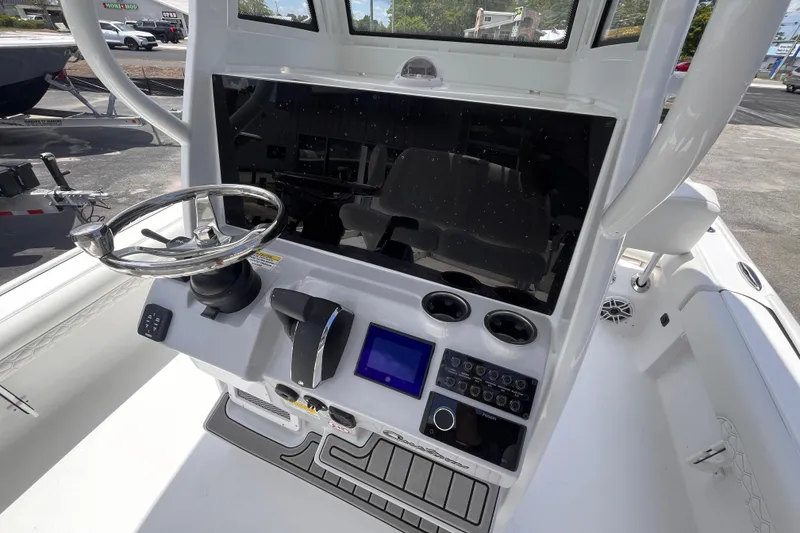 Slide: The Image of 2026 Tidewater 2500 Carolina Bay boat console with steering wheel and control panel. - 7