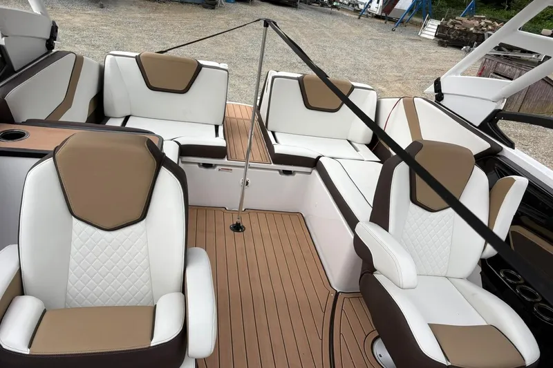 Slide: The Image of 2023 Yamaha Boats 252SD interior with white and brown seating, elegant design. - 17