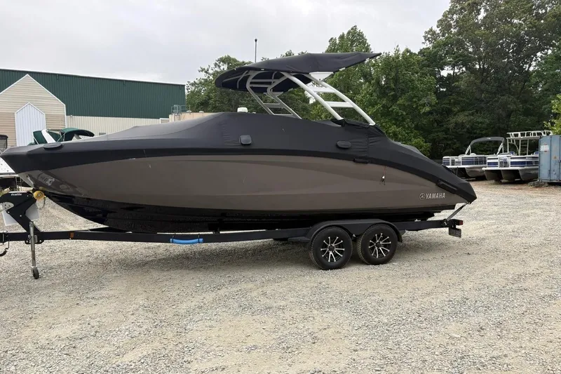 Slide: The Image of 2023 Yamaha Boats 252SD on trailer, covered, parked outdoors. - 5