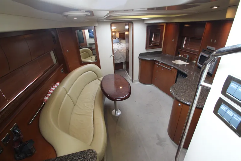 Slide: The Image of 2007 Sea Ray 44 Sundancer interior with elegant seating, kitchen, and modern amenities. - 30