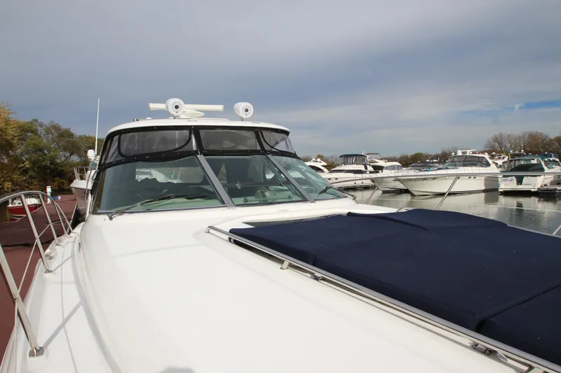 Slide: The Image of 2007 Sea Ray 44 Sundancer yacht docked at marina under cloudy sky. - 6