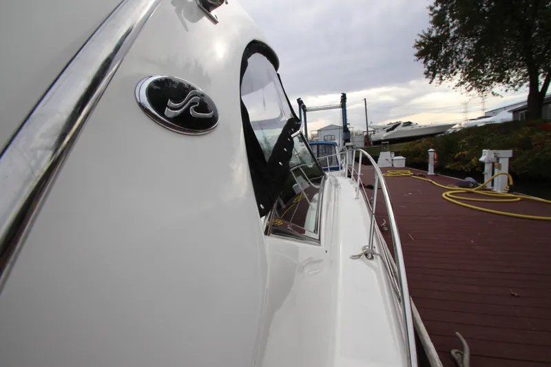 Slide: The Image of 2007 Sea Ray 44 Sundancer yacht docked, showcasing sleek design and polished exterior. - 8