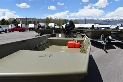 Slide: The Image of 2024 Lowe L1648M Aura Jon boat in parking lot with mountains in background. - 9