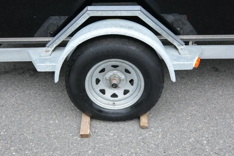 Slide: The Image of Trailer wheel of 2021 Alumaweld Super Vee 20, secured with wooden chocks. - 13