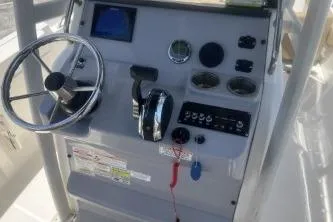 Slide: The Image of 2023 Trophy T22 boat dashboard with steering wheel and control panel. - 12