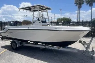 Slide: The Image of 2023 Trophy T22 boat on trailer, parked outdoors under a sunny sky. - 2