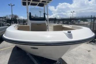 Slide: The Image of 2023 Trophy T22 boat with sleek design, docked under a partly cloudy sky. - 3