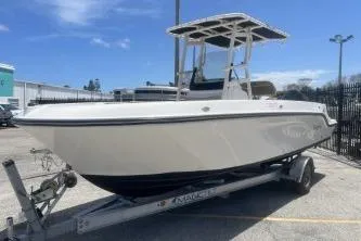 Slide: The Image of 2023 Trophy T22 boat on trailer, parked outdoors under clear blue sky. - 4