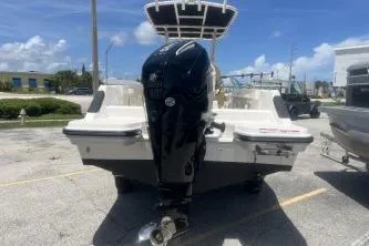 Slide: The Image of 2023 Trophy T22 boat with powerful outboard motor, parked outdoors under clear skies. - 6