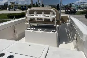 Slide: The Image of 2023 Trophy T22 boat interior with seating and rod holders, parked outdoors. - 7