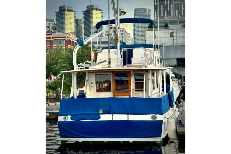 Slide: The Image of 1991 Grand Banks 36 Europa yacht docked in urban marina setting. - 2