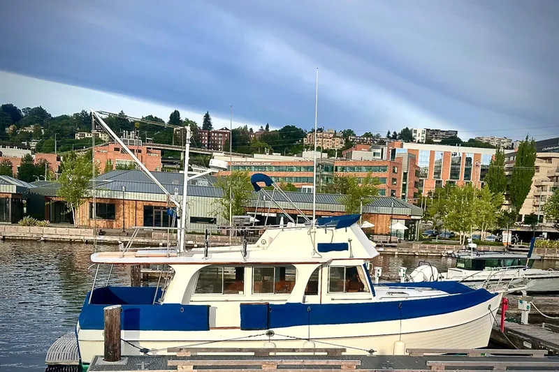 Slide: The Image of 1991 Grand Banks 36 Europa yacht docked in a scenic urban marina. - 5