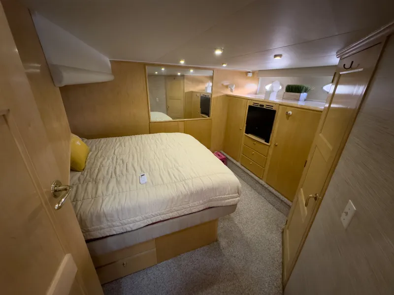 Slide: The Image of Interior of a 1999 Navigator 5300 yacht featuring a cozy bedroom. - 10