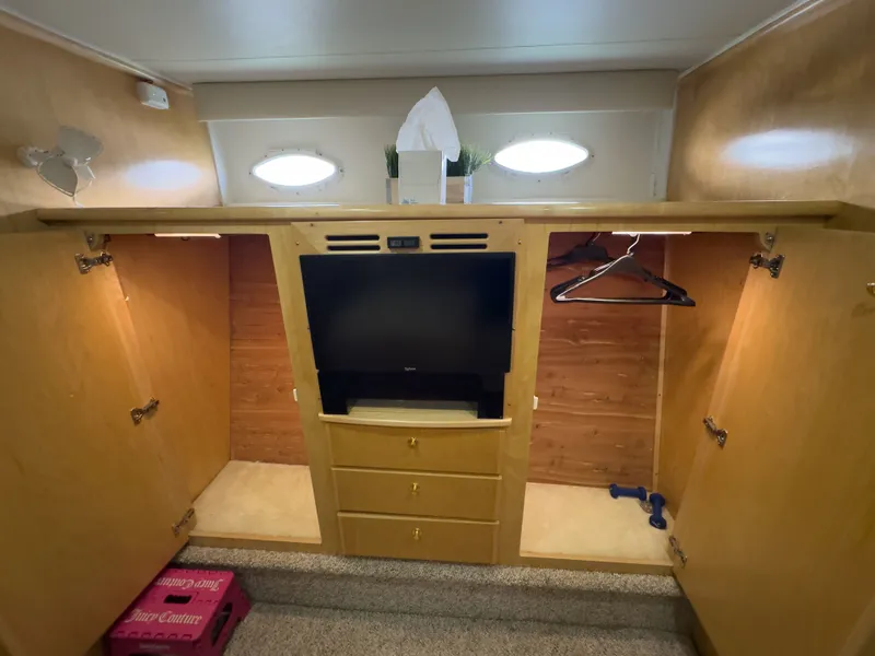 Slide: The Image of Interior of a 1999 Navigator 5300 yacht with cabinets and TV. - 13