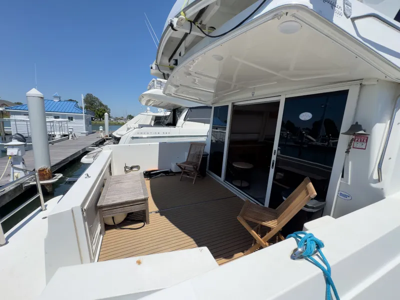 Slide: The Image of 1999 Navigator 5300 yacht docked with wooden deck and chairs. - 40