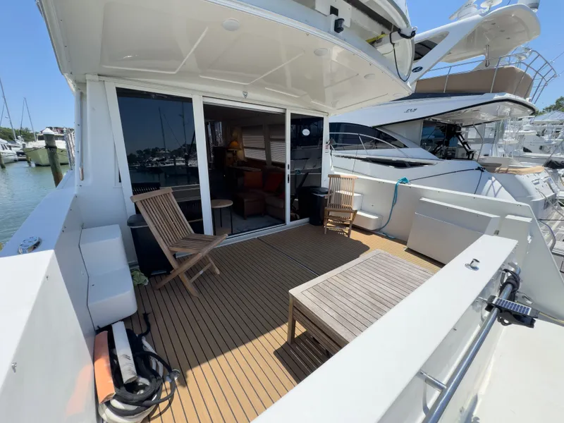 Slide: The Image of Deck of a 1999 Navigator 5300 with wooden furniture at the marina. - 41