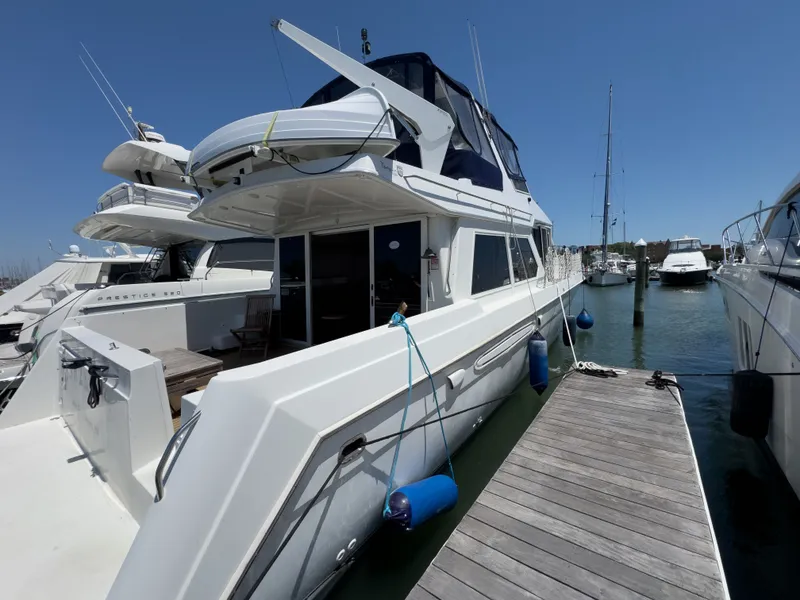 Slide: The Image of 1999 Navigator 5300 yacht docked at marina, sunny day, blue sky. - 42