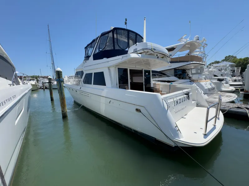 Slide: The Image of 1999 Navigator 5300 yacht docked in marina on a sunny day. - 43