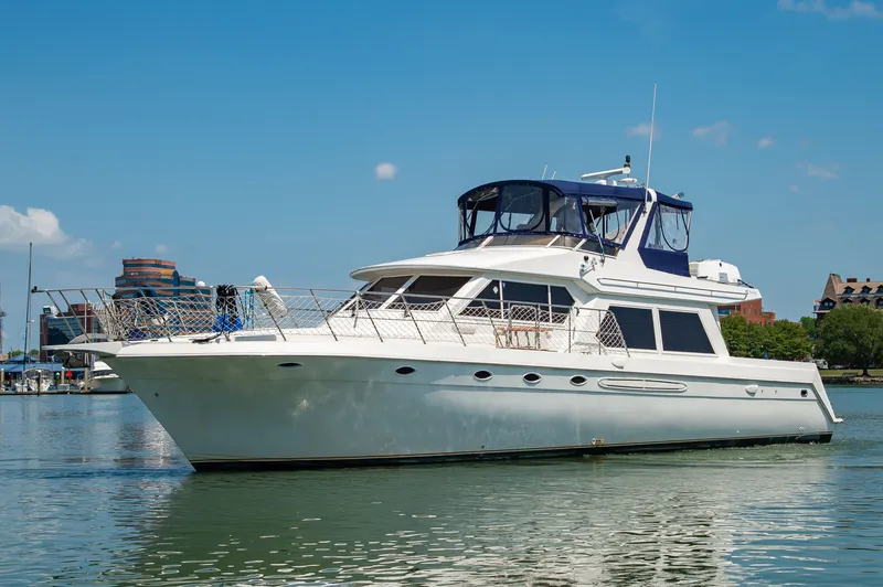 Slide: The Image of 1999 Navigator 5300 luxury yacht on calm waters. - 5