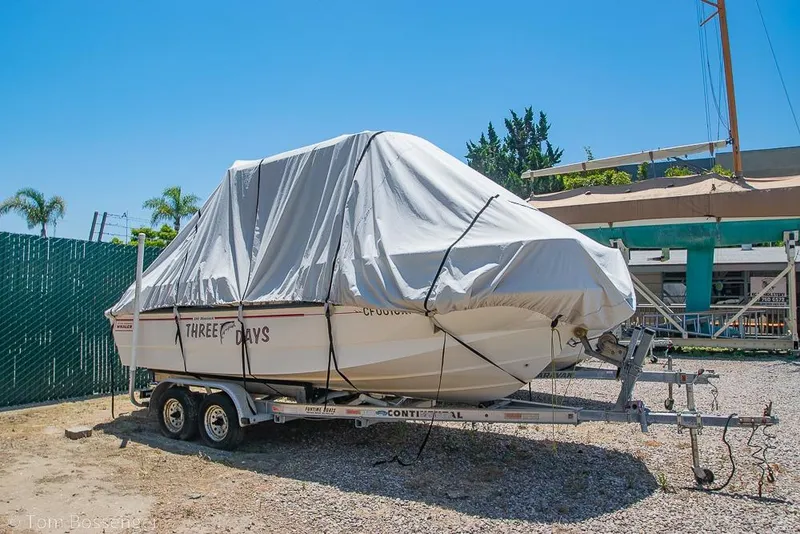 Slide: The Image of Covered 2008 Boston Whaler 190 Montauk boat on trailer in sunny outdoor setting. - 1