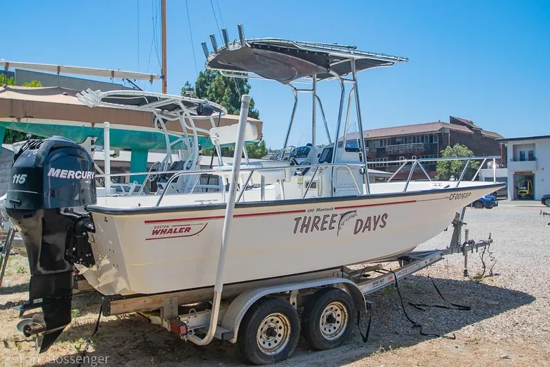 Slide: The Image of 2008 Boston Whaler 190 Montauk boat on trailer with Mercury engine, named "Three Days." - 2