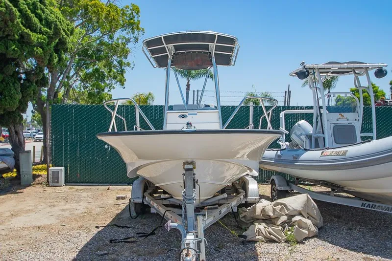 Slide: The Image of 2008 Boston Whaler 190 Montauk boat on trailer, parked outdoors. - 4