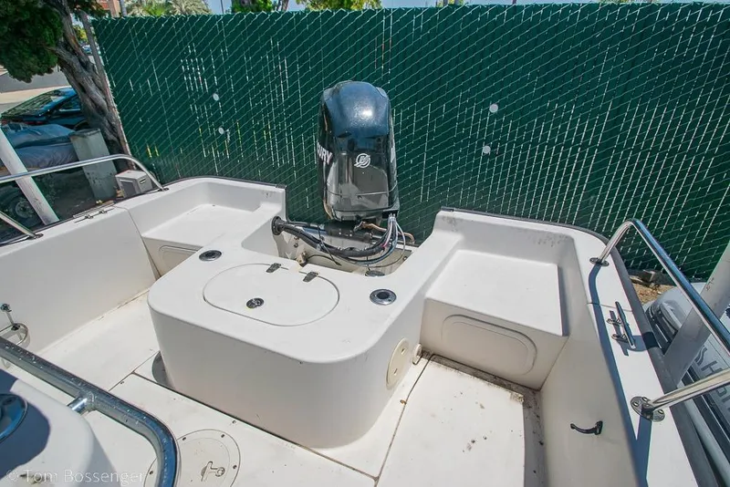 Slide: The Image of 2008 Boston Whaler 190 Montauk boat with Mercury engine, docked near green fence. - 8