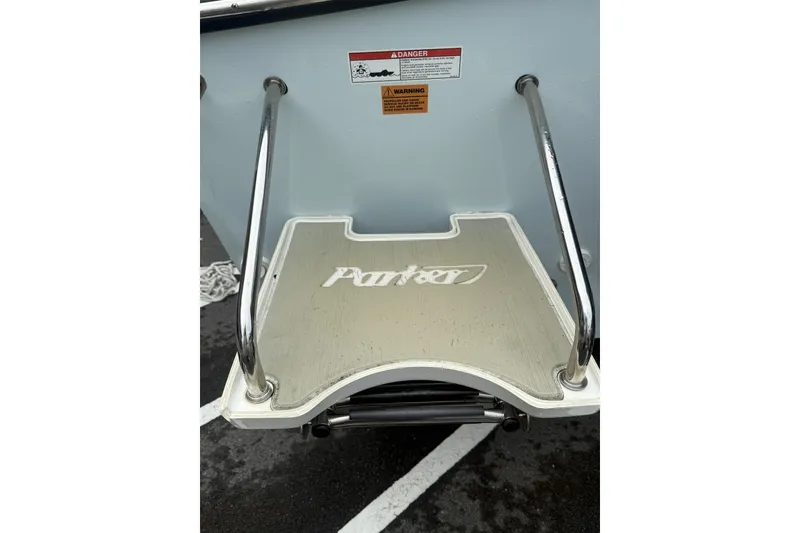 Slide: The Image of Parker 21 Special Edition 2019 boat swim platform with safety warnings and stainless steel rails. - 5