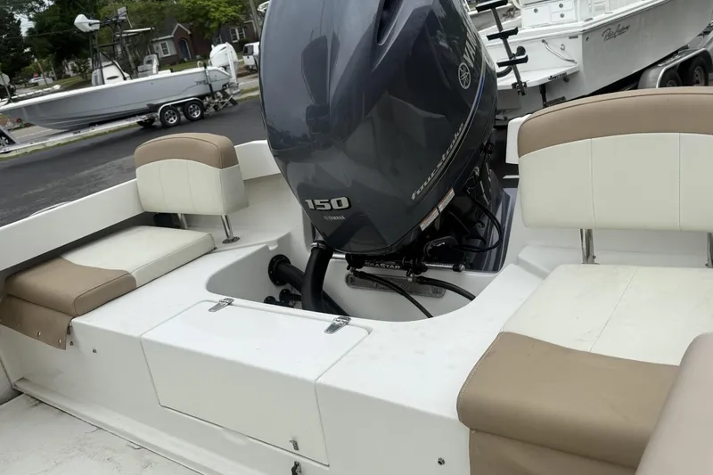 Slide: The Image of 2019 Parker 21 Special Edition boat with Yamaha 150 engine, featuring beige and white seating. - 6