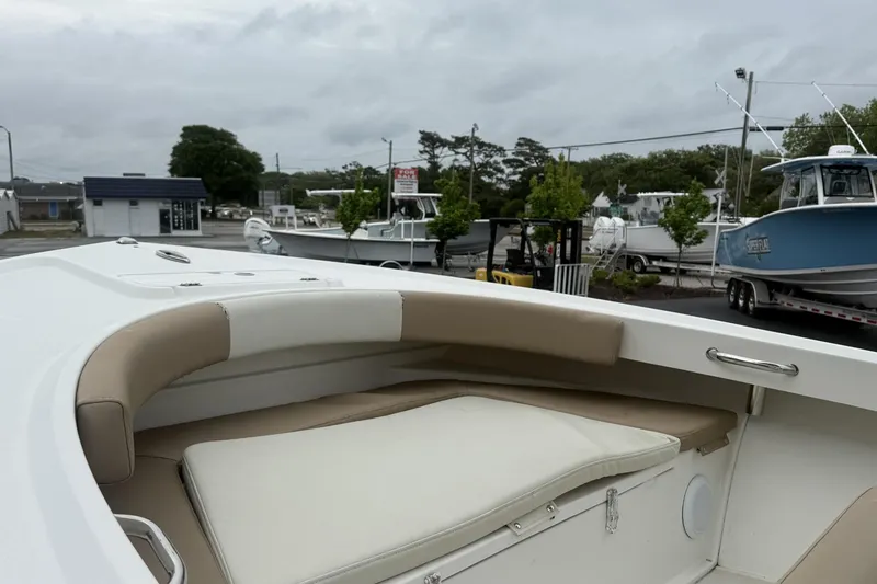 Slide: The Image of 2019 Parker 21 Special Edition boat with cushioned seating, docked near other boats. - 7