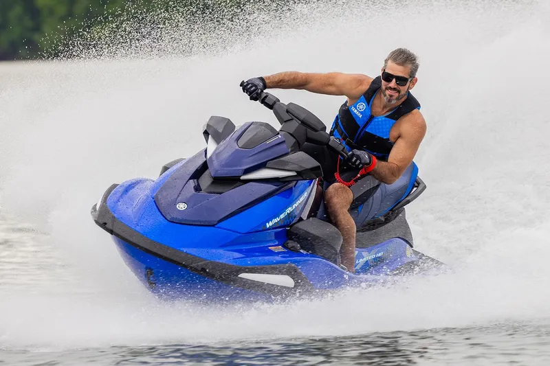 Slide: The Image of Manufacturer Provided Image: 2026 Yamaha WaveRunner VX Limited HO jet ski speeding on water, rider in blue vest. - 12