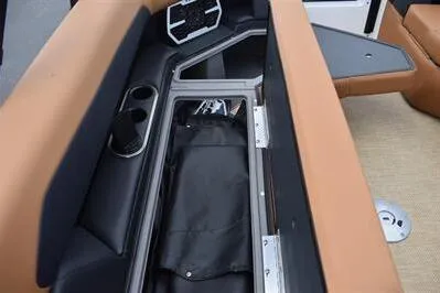 Slide: The Image of 2026 Princecraft Vouge 25 RL boat interior storage compartment with cup holders and seating. - 10