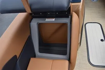 Slide: The Image of 2026 Princecraft Vouge 25 RL boat interior storage compartment with tan and gray seating. - 12