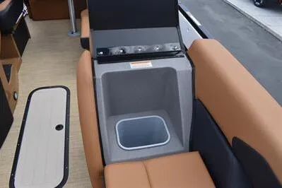 Slide: The Image of 2026 Princecraft Vouge 25 RL boat interior with built-in cooler and seating. - 13