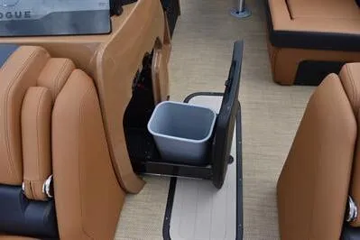 Slide: The Image of 2026 Princecraft Vouge 25 RL boat interior with tan seating and built-in trash bin. - 15