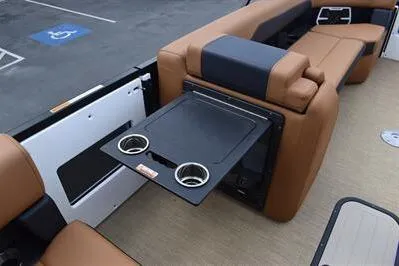 Slide: The Image of 2026 Princecraft Vogue 25 RL boat interior with fold-out table and cup holders. - 17