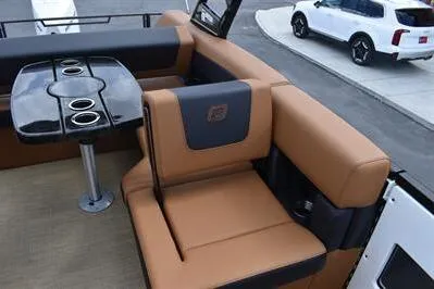 Slide: The Image of 2026 Princecraft Vogue 25 RL boat interior with tan seating and black table. - 20