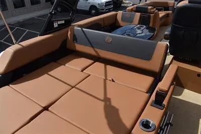 Slide: The Image of 2026 Princecraft Vogue 25 RL boat interior with luxurious tan seating and cup holders. - 22