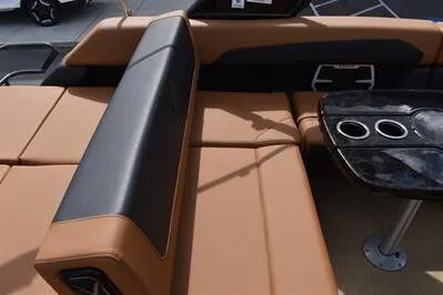 Slide: The Image of 2026 Princecraft Vouge 25 RL boat interior with tan seating and black table with cup holders. - 25