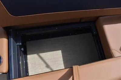 Slide: The Image of Storage compartment of 2026 Princecraft Vogue 25 RL boat with tan seating. - 26