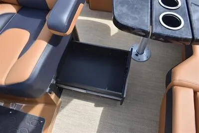 Slide: The Image of 2026 Princecraft Vouge 25 RL boat interior with storage drawer and cup holders. - 33